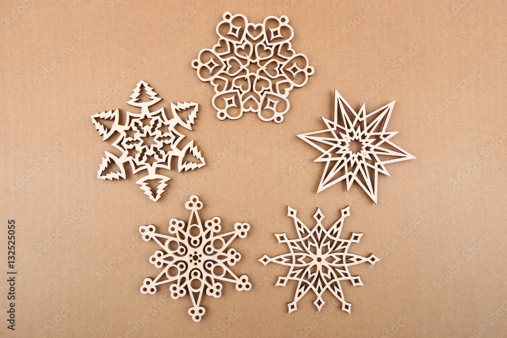 Wall mural Laser cut wood snowflakes ornaments.  Wooden snowflakes on carton.