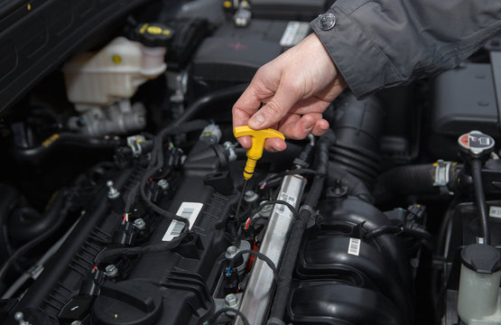 A man are checking engine oil level