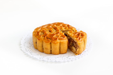 Traditional mooncake with mix five nuts filling on paper doily, dessert for the Chinese mid autumn festival.