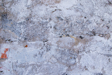 Old cement plaster white and beige scratched wall surface