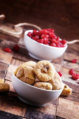 Dried figs and sweet cherry, vintage wooden background, selectiv
