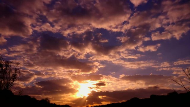 Time lapse video Sunset through clouds