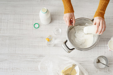 Woman makes the dough in the pan