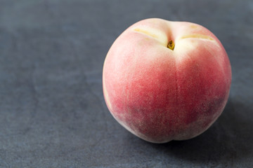 Fresh white peach on the slate background
