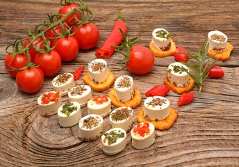 Obraz na płótnie Canvas appetizers cheese and bruschetta with herbs, tomato and chilli peppers,Vegetarian starter appetizer