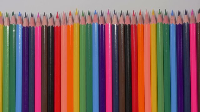 Set of multicolored pencils moving from right to left, sharp ends, pluralism, art, tools for expressing imagination, art. Stop motion. Close up, 4K Ultra HD.
