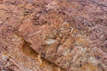 Fototapeta premium Irregular pattern orange stone wall