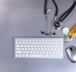 Technology with medical stethoscope and medicine on table 