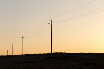 Electric poles at sunset