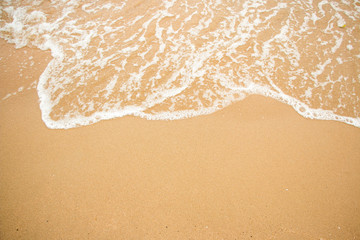 Fototapeta na wymiar Waves on a sandy beach in the summer.