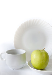 Fototapeta na wymiar Green apple on a white plate