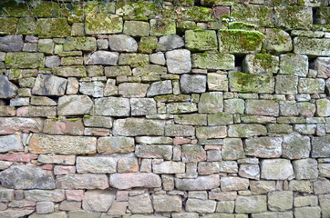 Mit Moos bewachsene Natursteinmauer