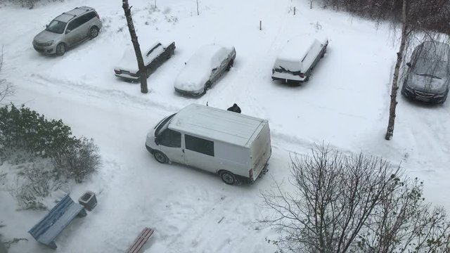 man got out of a van in the winter. top view