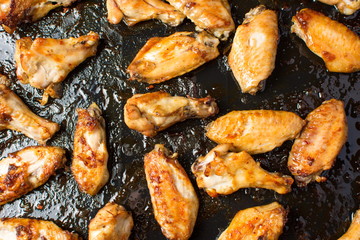 bbq chicken wings on a black plate