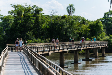 Tourists walking over a bridge to the Iguazu Fall in Argentina