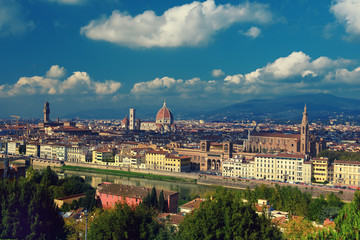 Fototapeta na wymiar View of the beautiful medieval italian city and culture capital - Florence with cathedrals and bridges over river and blue cloudy sky. Travel outdoor sightseeing historical background.