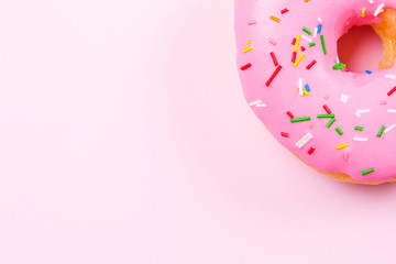 Pink round donut on pastele background. Flat lay, top view.