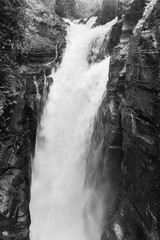 Portrait of high waterfall as part of the Iguazu Waterfall with long exposure in black and white