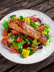 Fried Salmon steak with fresh vegetables salad. concept healthy food.