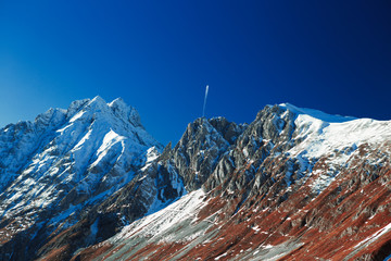 mountain landscape condensation trail from an airplane
