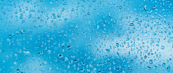 Rainy wet cold blue sky eco seasonal natural abstract background with water drops