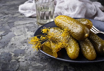 Pickled cucumbers in black plate