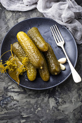 Pickled cucumbers in black plate