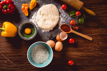 Fresh and tasty homemade pizza on wooden table with ingredients