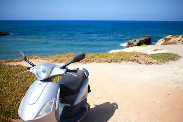 Scooter on the beach, carefree summer landscape, lifestyle