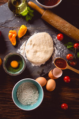Fototapeta premium Fresh and tasty homemade pizza on wooden table with ingredients