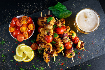 Chicken skewers marinated in turmeric yogurt served with lemon and mint
