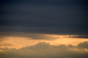 Fototapeta na wymiar dark storm cloud with sunlight behind