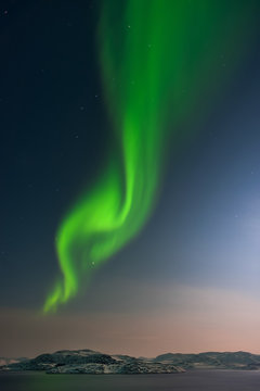 A beautiful and marvelous aurora dancing over the Barents Sea - marginal sea of the Arctic Ocean. Kola Peninsula, Murmansk oblast