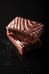 two brownies on black background