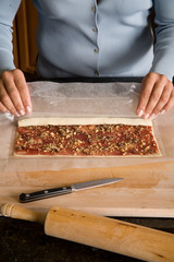 rolling dough with cherry filling