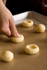 Fototapeta na wymiar pressing thumb into cookie dough