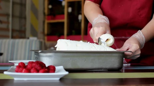 scooping vanilla ice cream ball