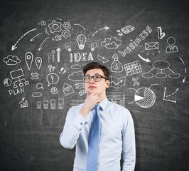 Young man with glasses and business idea sketch