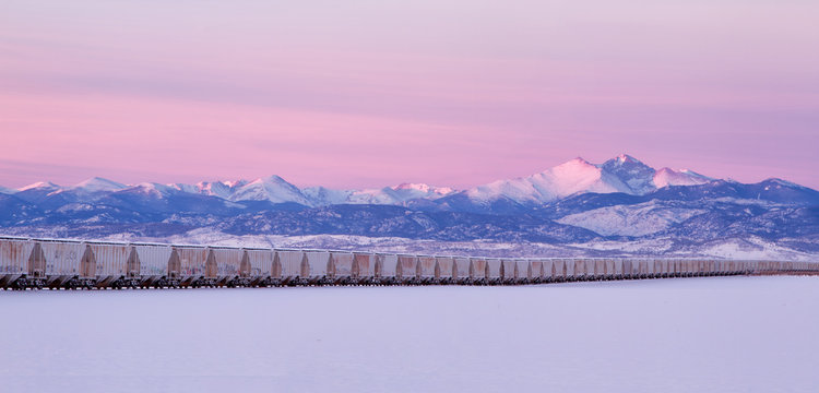 Freight Train leading to Longs Peak during a winter sunrise pano