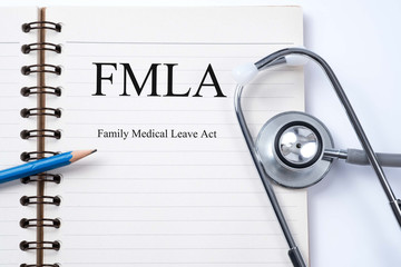 Stethoscope on notebook and pencil with  FMLA family medical lea - obrazy, fototapety, plakaty
