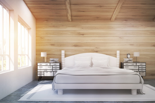 Double bed in a wooden room, toned