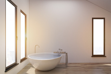 Obraz na płótnie Canvas Bathroom in the attic with white tub