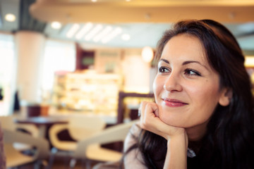 Young Woman Having Coffee In A Cafe