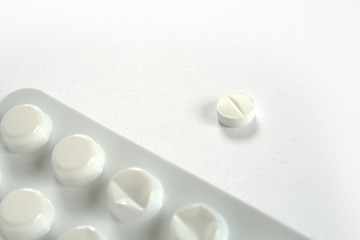 One pill and blister on white