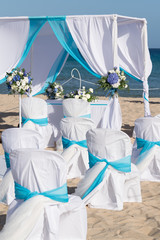 Setting up a wedding on the beach.