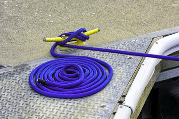 Blue mooring rope tied off to yellow cleat