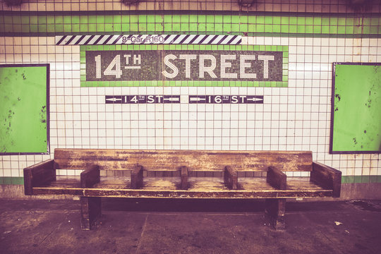 Retro style image of Bench at New York City subway station with vintage tile wall