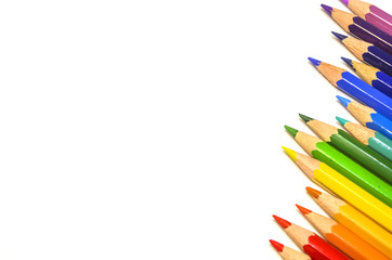 Palette of color pencils on white paper