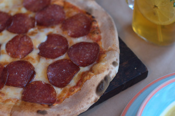 Pizza with sausage on the table in the restaurant
