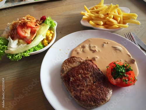 quot;Beef hamburger steak with mushroom sauce and baked tomato setquot; Stockfotos und lizenzfreie 